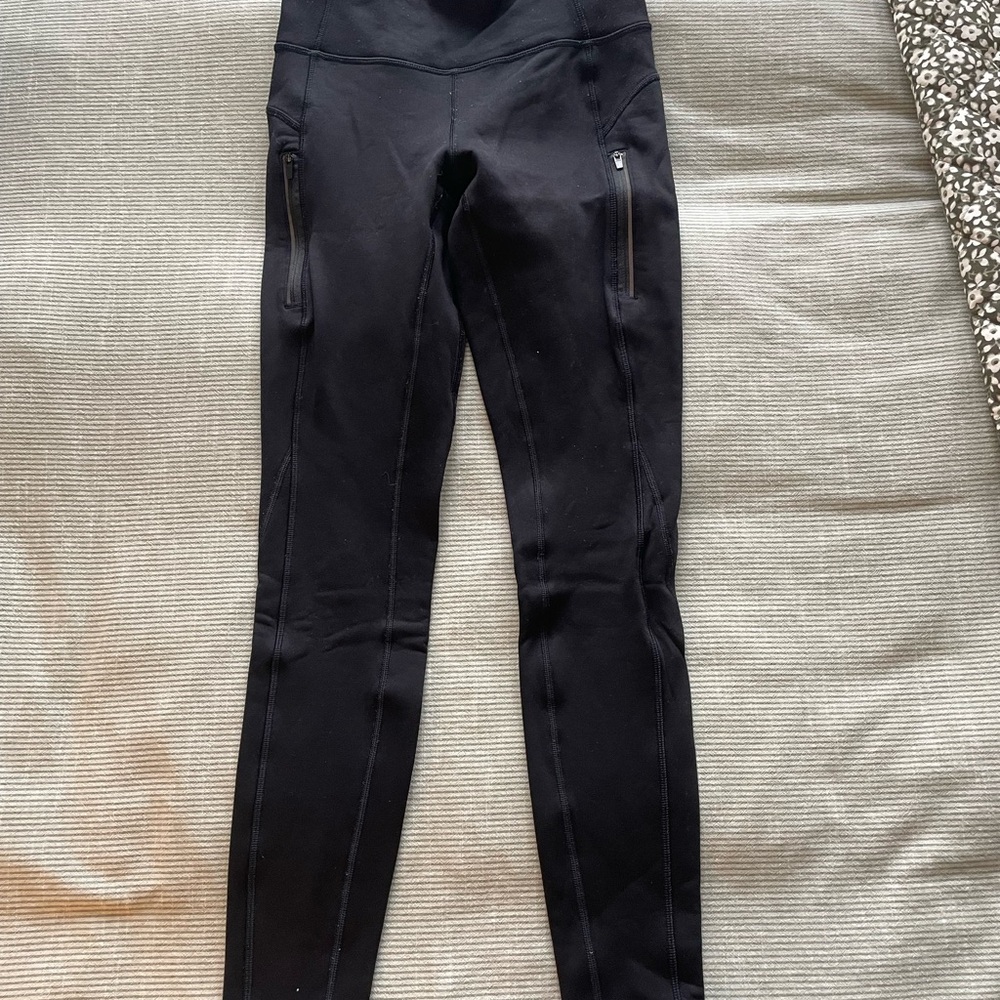Athleta Black Fleece Leggings with zipper pockets.